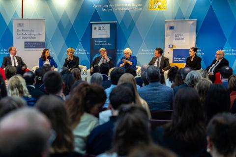 Photo of speakers at the panel, seating in one row