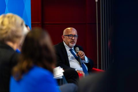 Photo of Wojciech Wiewiorowski seating in the chair and speaking