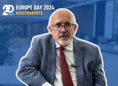 Blue background layer over the picture where Wojciech Wiewiorowski speaks and in the left corner a white logo of the EDPS with title Europe Day 2024 with hashtag Use your vote