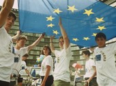 people in white T-shirts holding EU flag